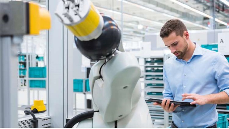 Image of a man controlling a robot via smart device
